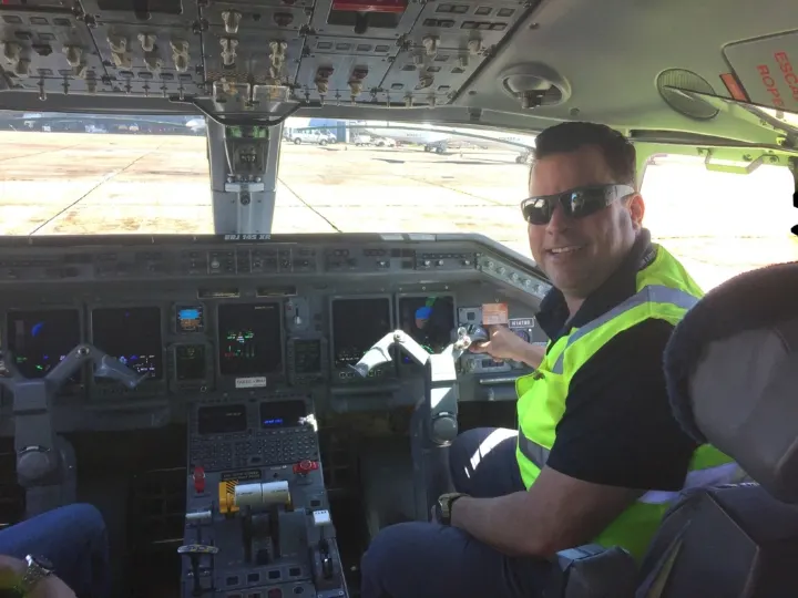 Carlos in the cockpit holding on to the yoke