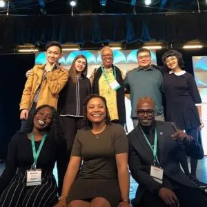 Five women and three men pose for the camera