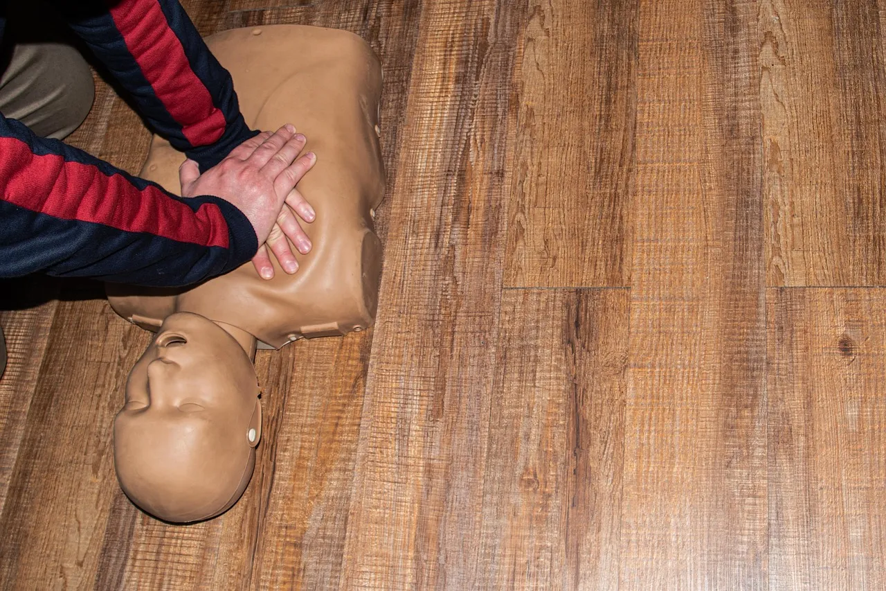 Students giving CPR to mannequin